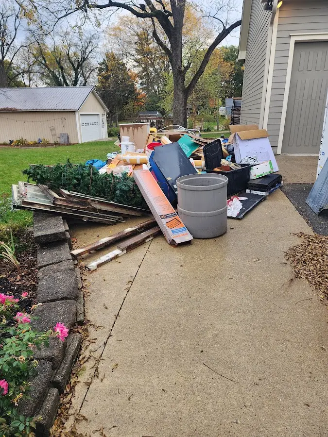 Dumpster being loaded with debris for 12 Yard Dumpster Rental in Palmetto Bay